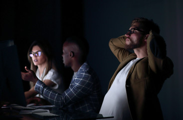 close up.serious businessman on the background of colleagues