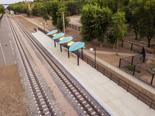 two railway tracks near the empty station near park