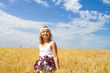 Inner world of the child . Meditation as way of life . Relaxation in the fresh air . Portrait of the happy beautiful young woman . in the field of wheat 
