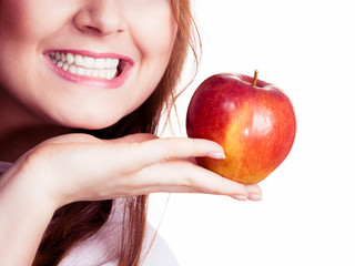 Woman holds apple fruit close to face, isolated