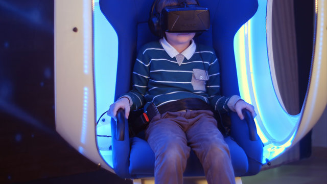 Excited boy enjoying virtual reality attraction