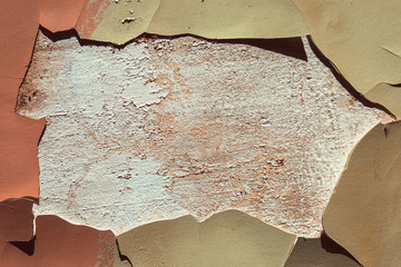 A fragment of an old aged wall with cracked paint surrounded blank dirty center