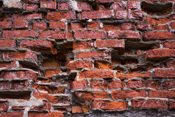 Tattered red brick wall 