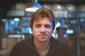 Young man brunet eating in cafe.