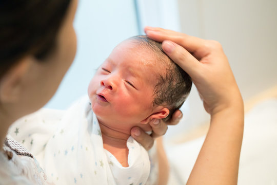 Mother Giving Her Baby First Bath, Bathing Newborn Concept