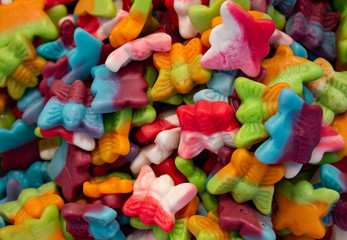 Fototapeta na wymiar Approach of multicolored candies. Sweet chewy gummies