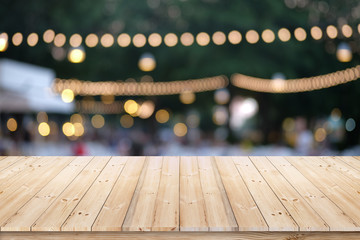Wood plank on blur bokeh evening outdoor party or fair festival.