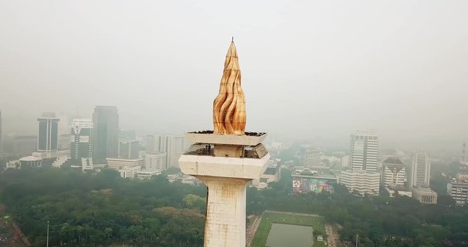 JAKARTA, Indonesia - May 30, 2018: Aerial footage of National Monument Jakarta from a drone during misty morning. Shot in 4k resolution