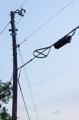 Detail of top of telephone pole with cable and phone lines