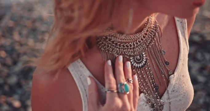 Close up of hippie woman's jewelery at the beach