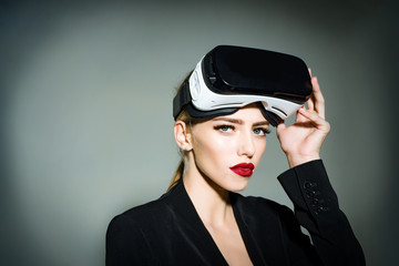 Beautiful woman in virtual reality headset. Sensual attractive girl with makeup in virtual reality goggles at head. Future. Future technology concept. Girl using VR headset.