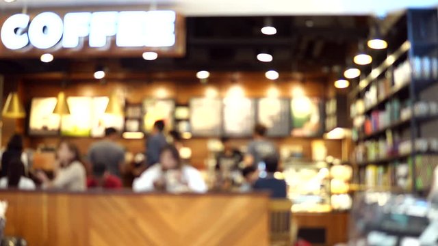 Blurred footage of coffee shop with people drinking coffee. 4K video with defocused effect.