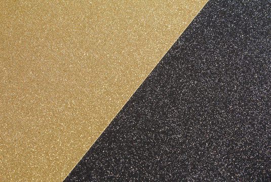 A Close Up Of Gold Craft Glitter Paper Placed Against Black Craft Glitter Paper To Create A Black & Gold Textured Background.