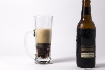 glass of dark beer isolated on white background