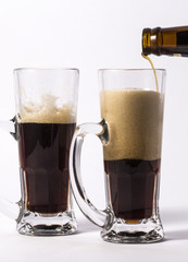 glass of dark beer isolated on white background