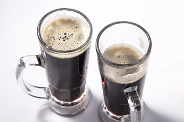 glass of dark beer isolated on white background