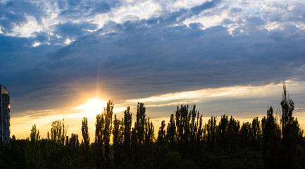 Obraz premium Landscape with dramatic light - beautiful golden sunset with saturated sky and clouds.
