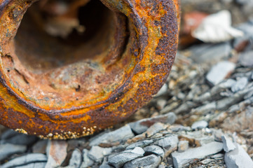 Very rusty metal on a gray cracked rock