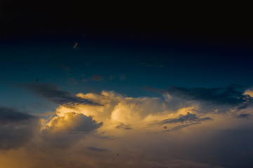 Landscape with dramatic light - beautiful golden sunset with saturated sky and clouds.