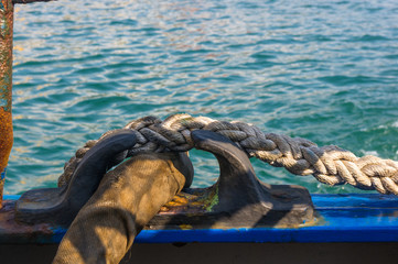 Old braided rope on the wooden deck of a sea boat