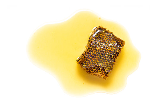 Piece of behive or honeycomb with honey isolated on white background