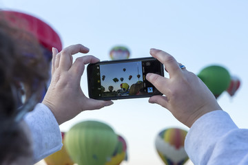 Spectator recording the balloon races from the field
