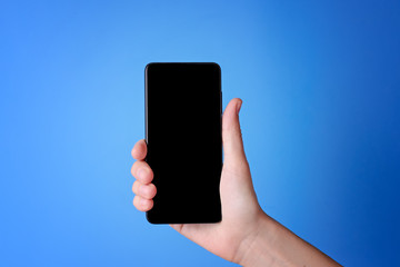 Woman holding mobile phone with isolated display