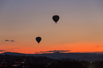 Hot air balloon takes off at sunrise