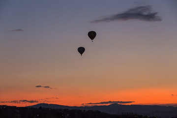 Hot air balloon takes off at sunrise