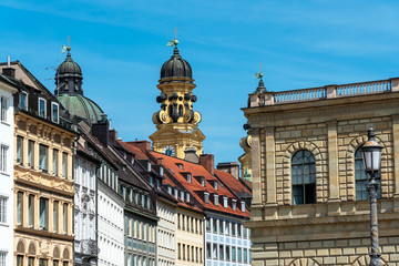 Old houses in downtown Munich with the Theatine Church in the back