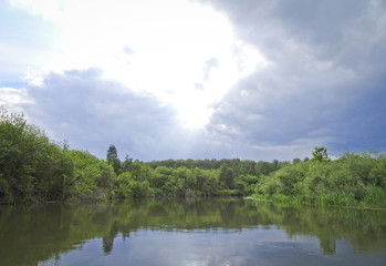 Obraz na płótnie Canvas Summer landscape: calm river and storm clouds