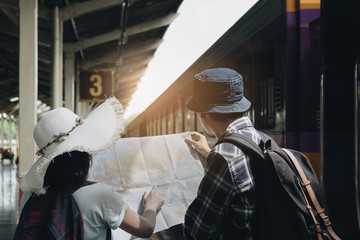 Yong Couple traveler with map because lost at train station. Travel and Active lifestyle concept.