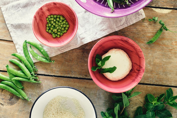 Top view set ingredients cooking vegetarian risotto green peas mint goat cheese wooden rustic table Healthy food concept