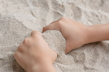 The child is playing with the sea sand. Sypet, flying away. Relax, meditation