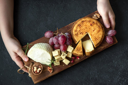 cheese platter and hands of cheese maker