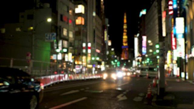 ROPPONGI,  TOKYO,  JAPAN - CIRCA JUNE 2018 : TAXI and CAR passing at night time in busy street around Roppongi crossing area.  In blurred.