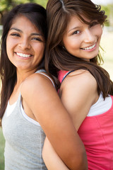 Sisters laughing and having fun outside.