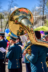 Performance of the brass band at the city festival. Musicians with french horn, trumpet, trumpet,...