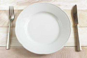 Diet Concept White Dish,knife and fork on wood table