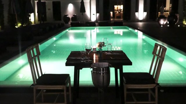 View Of A Romantic Table Staying Next To The Swimming Pool