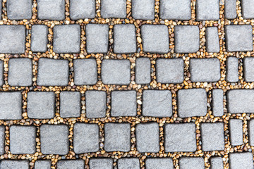 Fototapeta premium Cobblestone stone block footpath texture pattern background