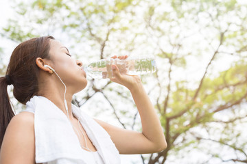 Portrait Of Young Woman Drinking Water After Jogging