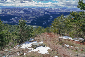 Big mountain point view of valley with cloudy dark sky