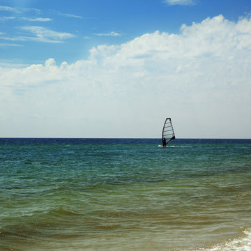 Sea with waves and windsurfing