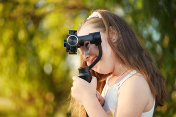 girl with a camera and stabilizer removes.