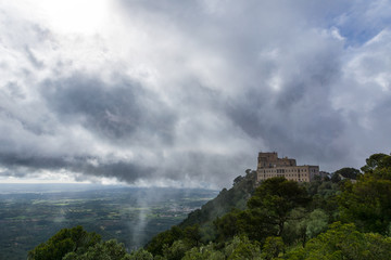 Mallorca, Magic breakthrough of sunlight through misty cloudy sky on top of mountain Sant Salvador