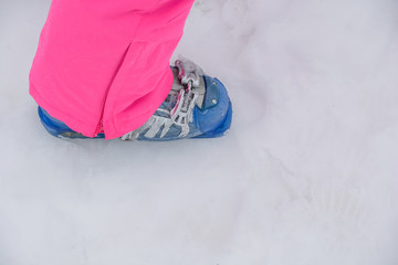 Blue modern ski boot equipment on cold mountain snow