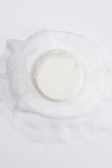 top view of delicious cottage cheese on cheesecloth on white tabletop