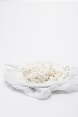 delicious cottage cheese on cheesecloth on white surface