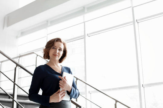 Female lawyer standing with tablet in office